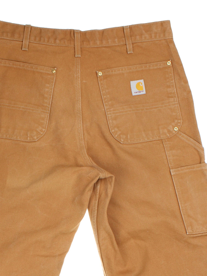 Carhartt Double Knee Jeans in tan colourway with multiple pockets and the logo embroidered on the back.