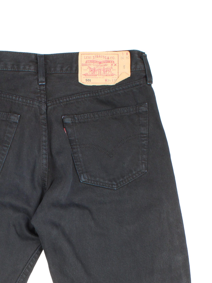 Levi Strauss 501 jeans in black colourway with multiple pockets and the logo embroidered on the back.