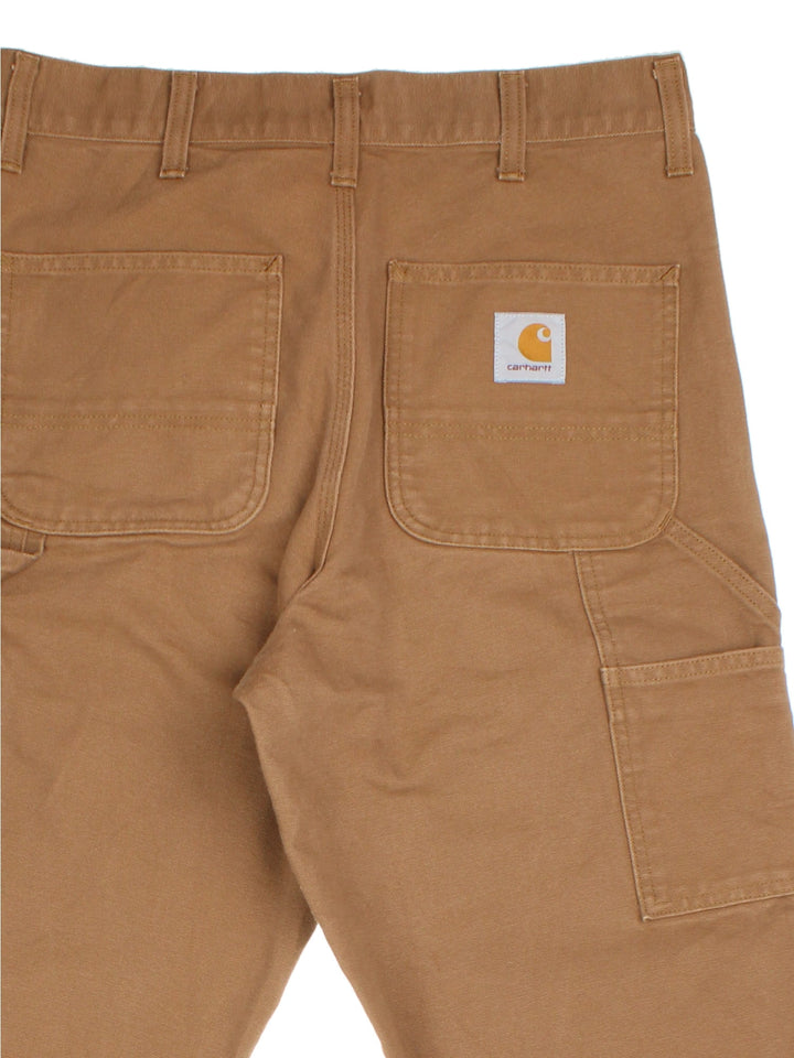 Carhartt Double Knee Jeans in a brown colourway, with multiple pockets and embroidered logo on the back pocket.