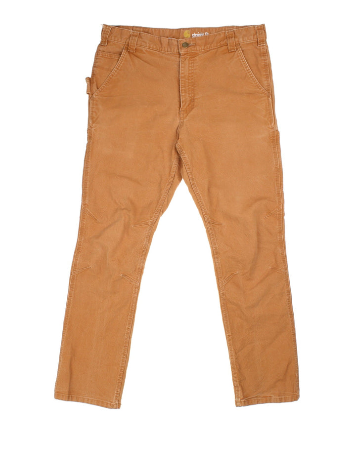 Carhartt Trousers in a brown colourway, with multiple pockets and embroidered logo on the back pocket.