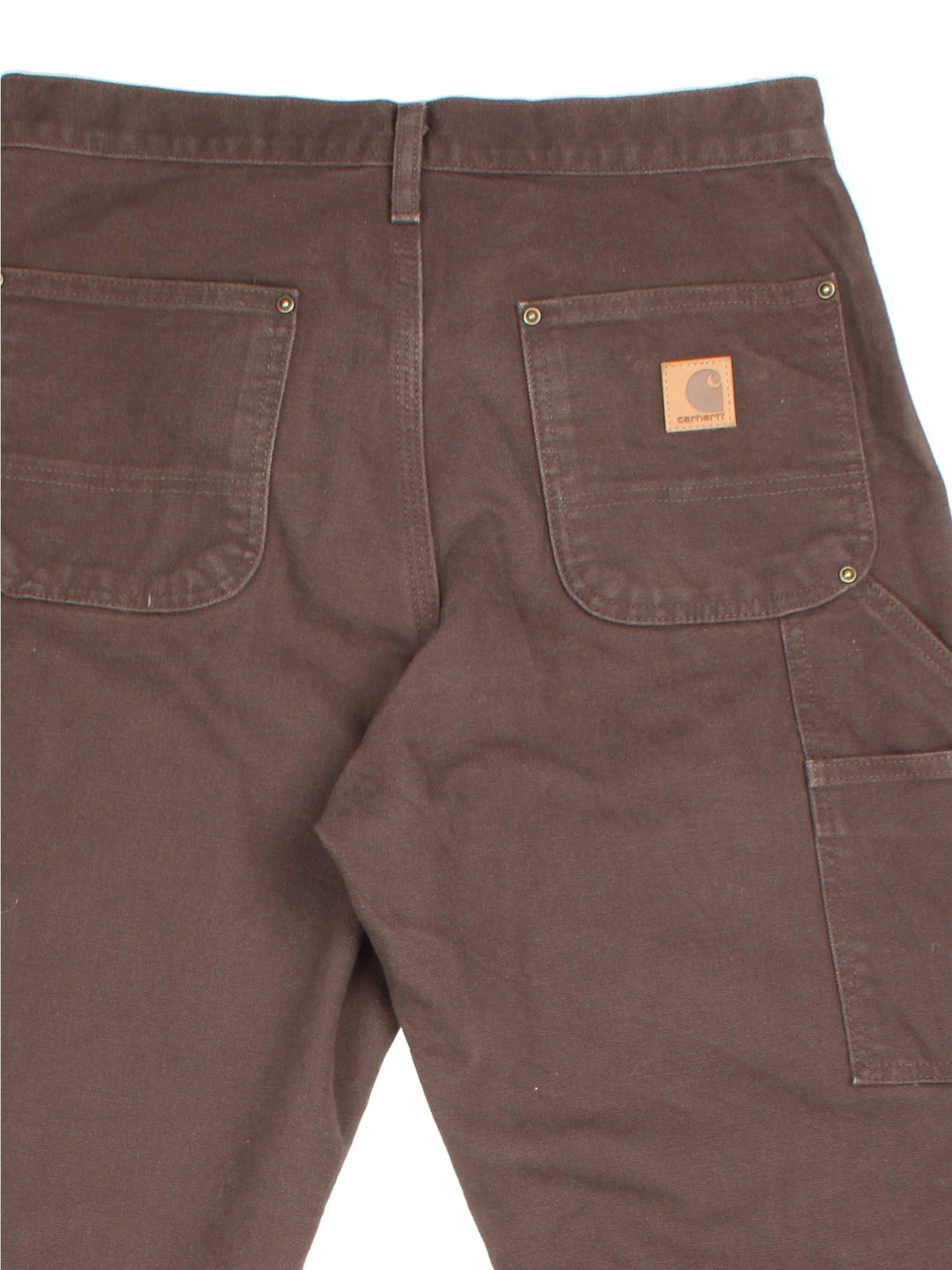 Carhartt Double Knee Jeans in a brown colourway, with multiple pockets and leather logo on the back pocket.