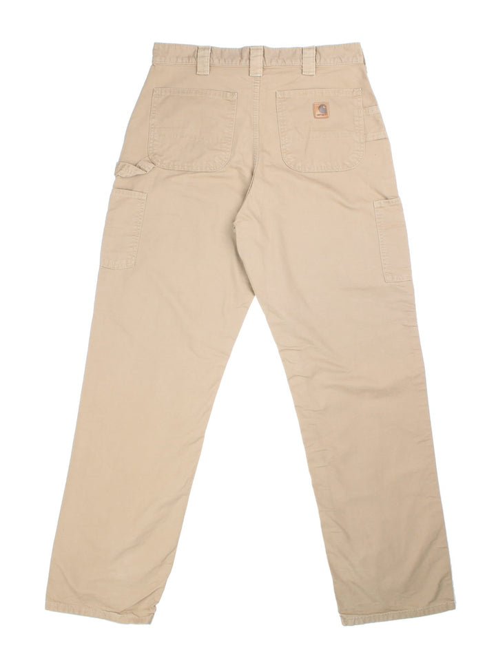 Carhartt Carpenter Trousers in tan colourway with multiple pockets and the logo embroidered on the back.