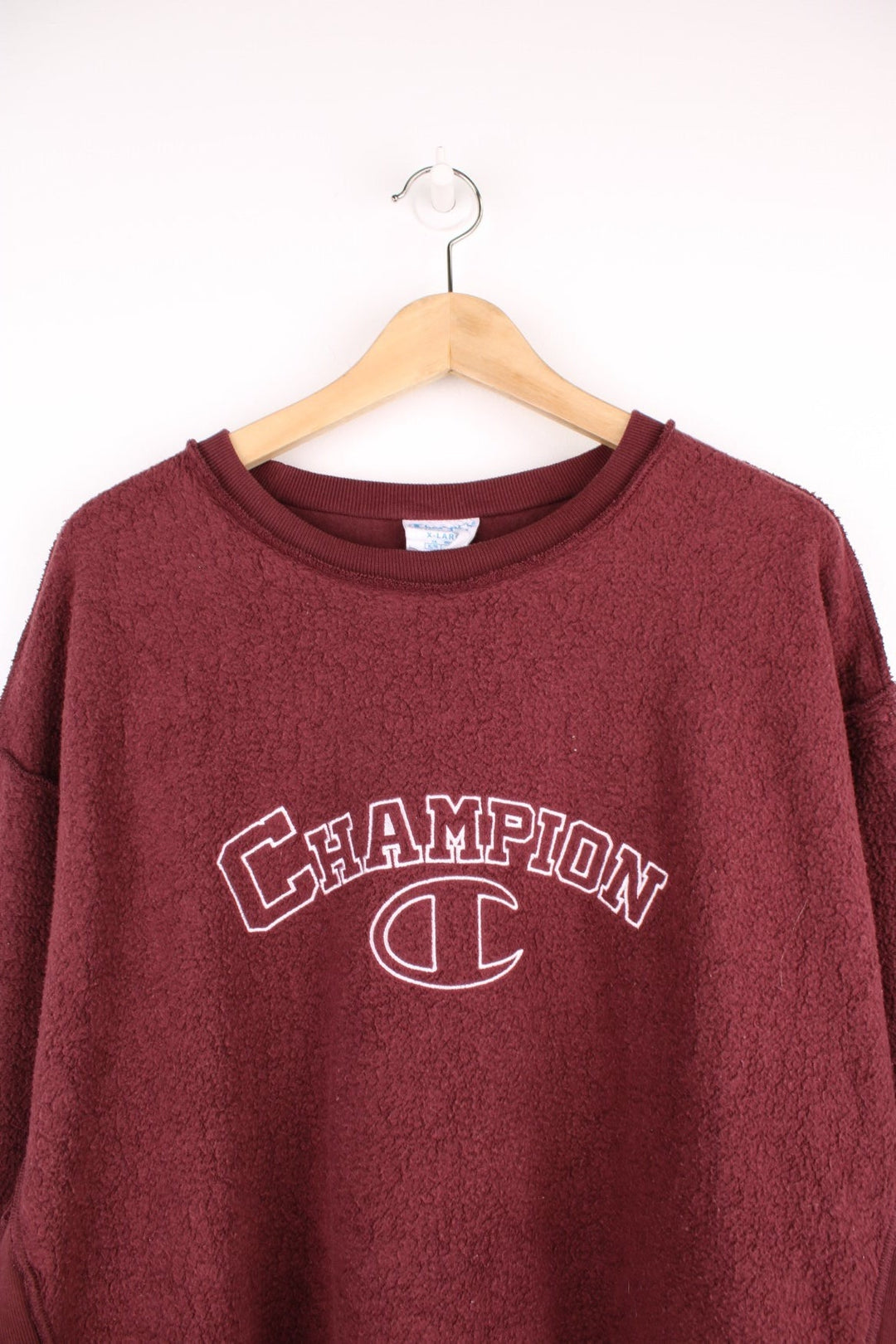 Champion Inside Out Reverse Weave Sweatshirt in a burgundy colourway and has the spell out logo embroidered across the front in white. 