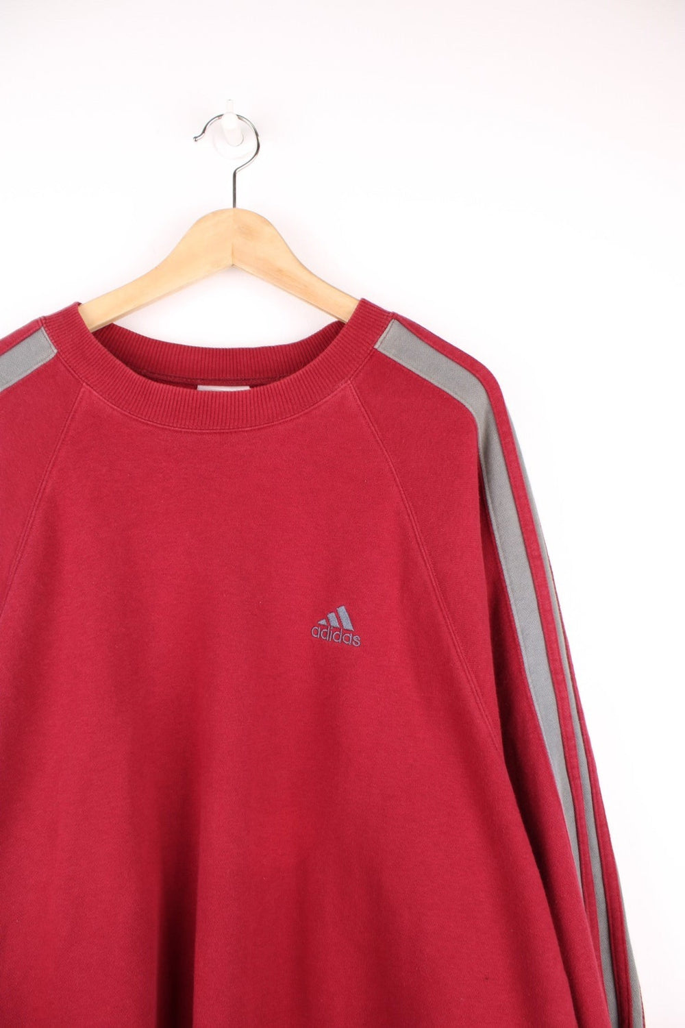 Adidas Sweatshirt in a red and grey colourway with the iconic three stripes going down the arms, and has the logo embroidered on the chest. 