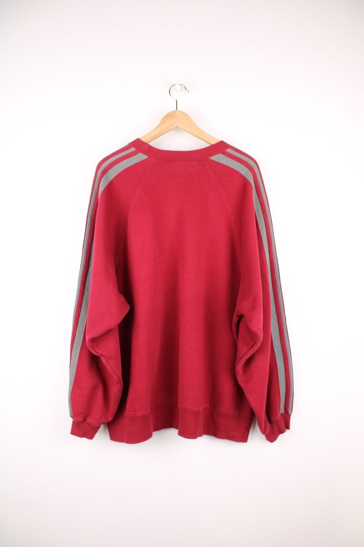 Adidas Sweatshirt in a red and grey colourway with the iconic three stripes going down the arms, and has the logo embroidered on the chest. 