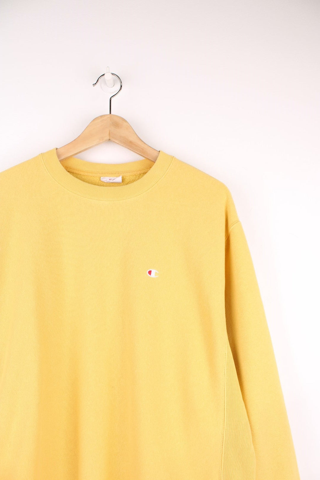 Champion Reverse Weave Sweatshirt in a yellow colourway with the logo embroidered on the chest and left sleeve. 