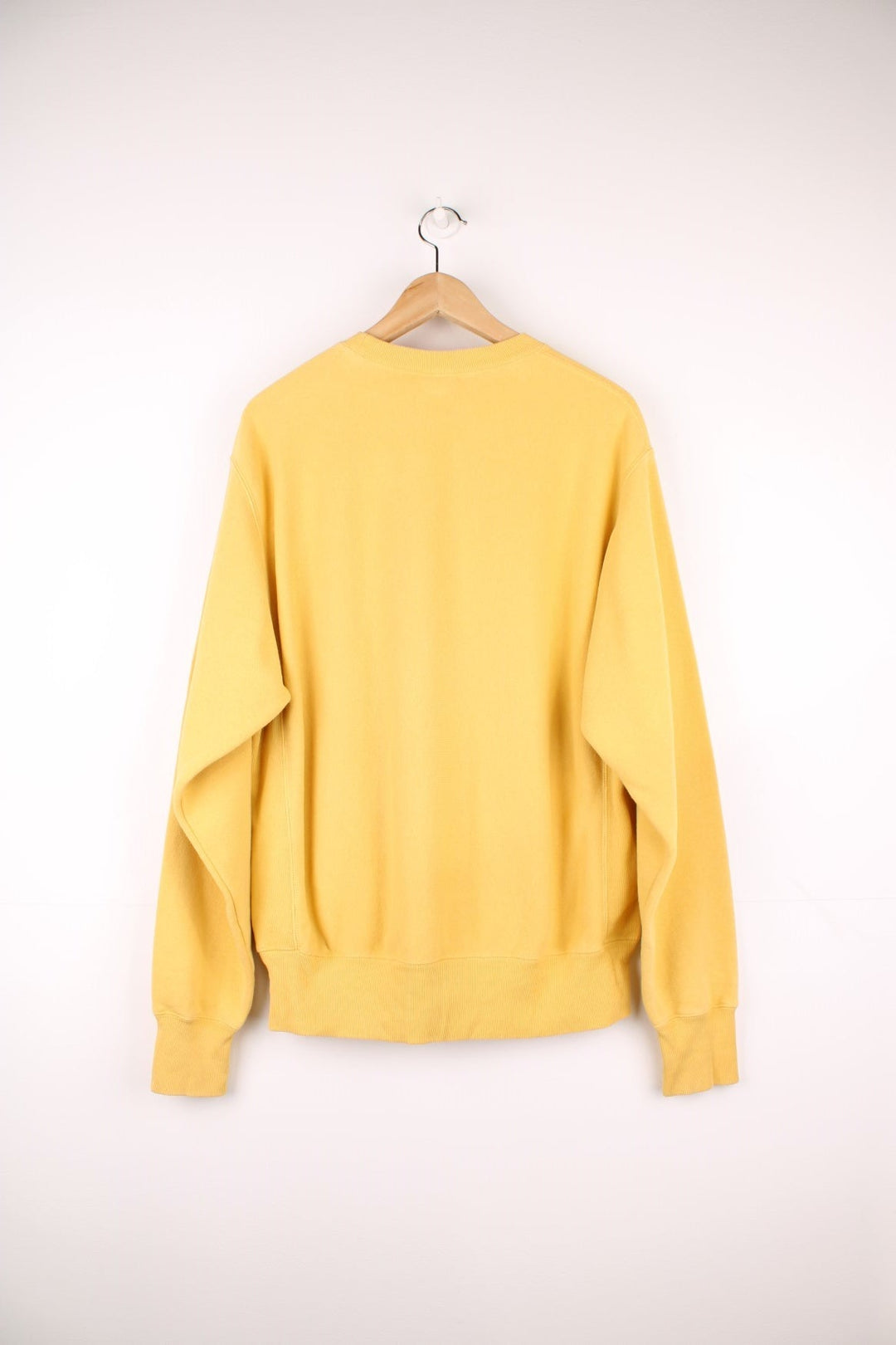 Champion Reverse Weave Sweatshirt in a yellow colourway with the logo embroidered on the chest and left sleeve. 