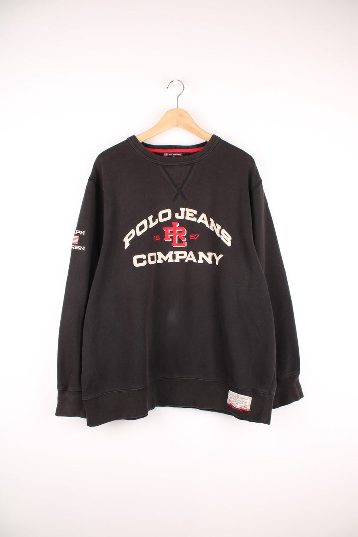 Ralph Lauren Polo Jeans Company Sweatshirt in a black colourway with the spell out logo embroidered across the front and on the right sleeve. 