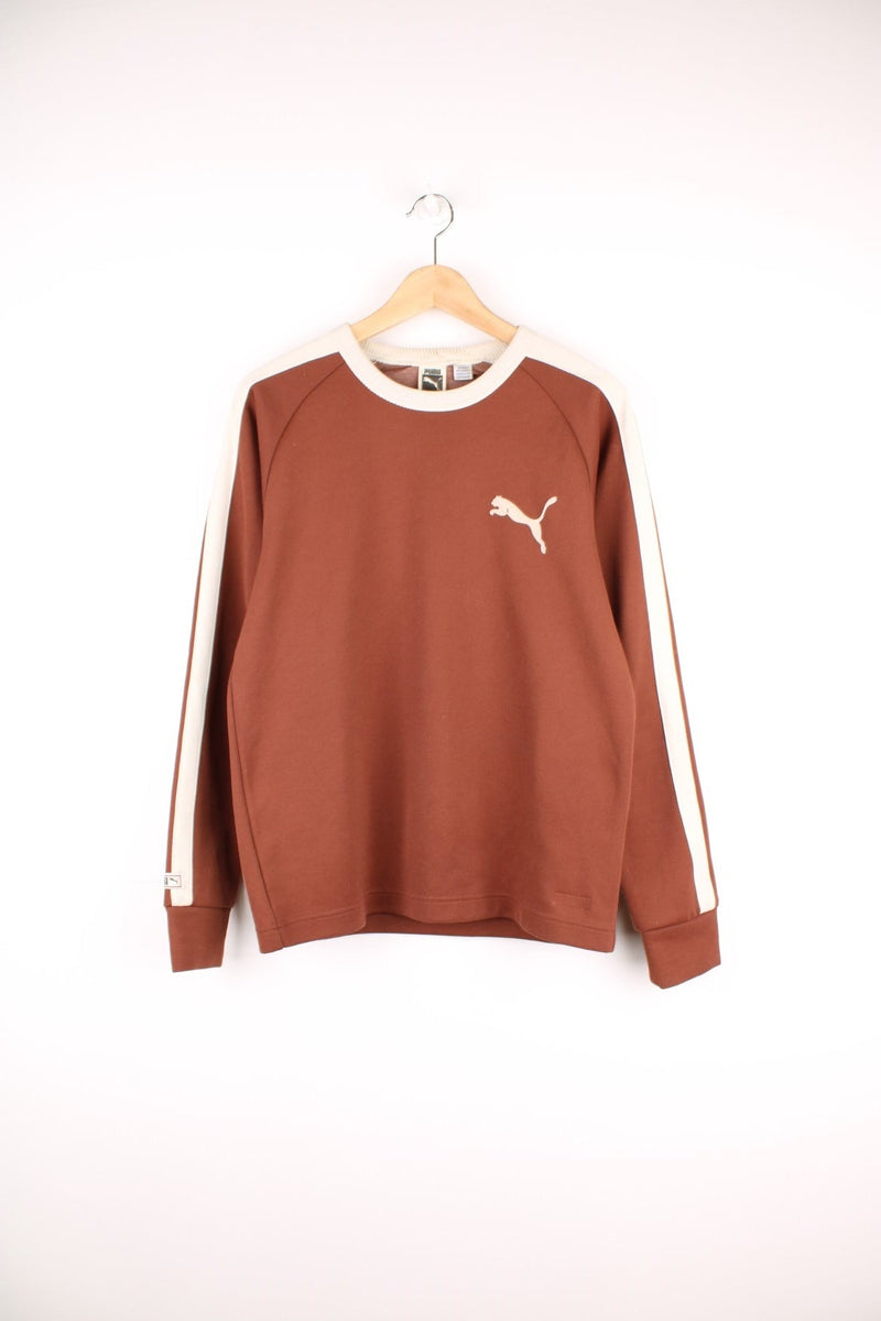 Puma Sweatshirt in brown and beige colourway with stripes going down the sleeves and the logo printed on the chest.