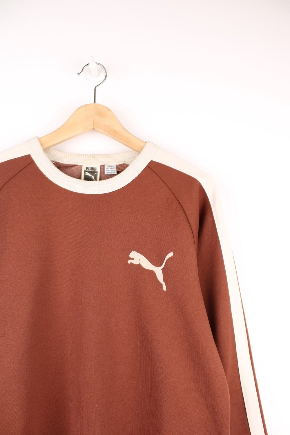 Puma Sweatshirt in brown and beige colourway with stripes going down the sleeves and the logo printed on the chest.