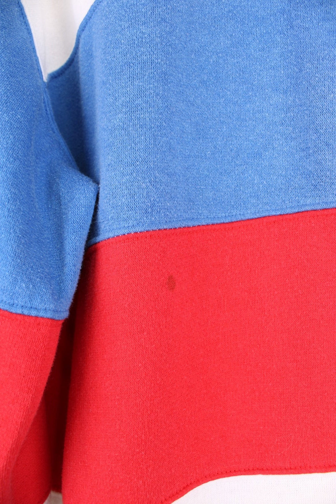 80's Nike Collared Sweatshirt in a white, blue and red block patterned colourway, quarter button up with a collar, and has the logo embroidered on the chest. 