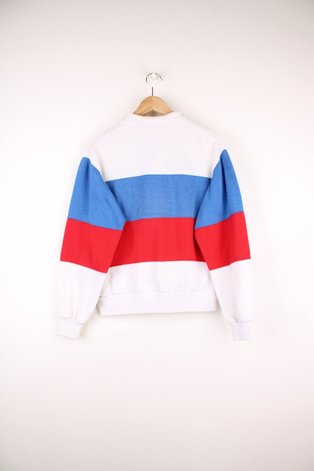 80's Nike Collared Sweatshirt in a white, blue and red block patterned colourway, quarter button up with a collar, and has the logo embroidered on the chest. 