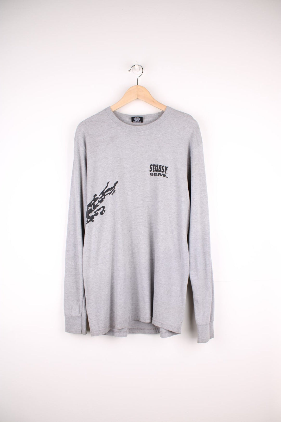 Stussy Gear Longsleeve T-Shirt in a grey and black colourway with the spell out logo printed on the front and motorbike racer going round the side and on the back.