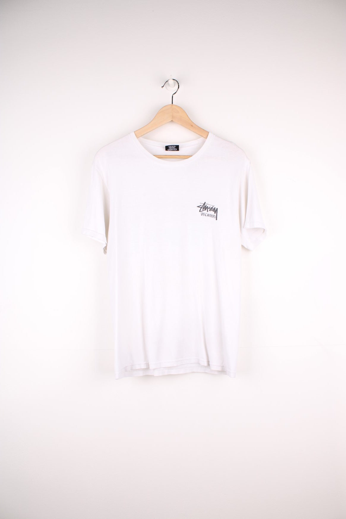 Stussy Vancouver T-Shirt in a white and black colourway with the spell out logo printed on the front and back. 