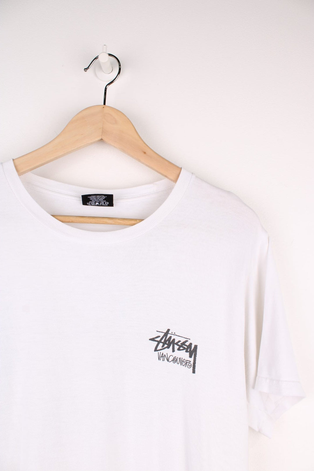 Stussy Vancouver T-Shirt in a white and black colourway with the spell out logo printed on the front and back. 