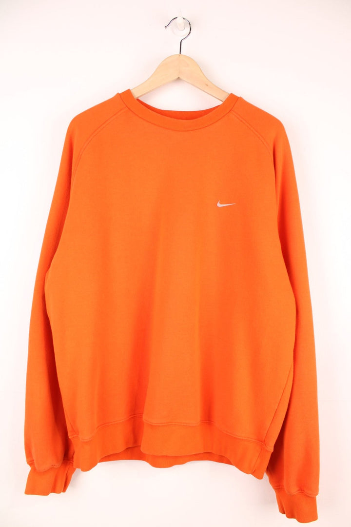 Nike sweatshirt in orange with the logo embroidered on the chest. 