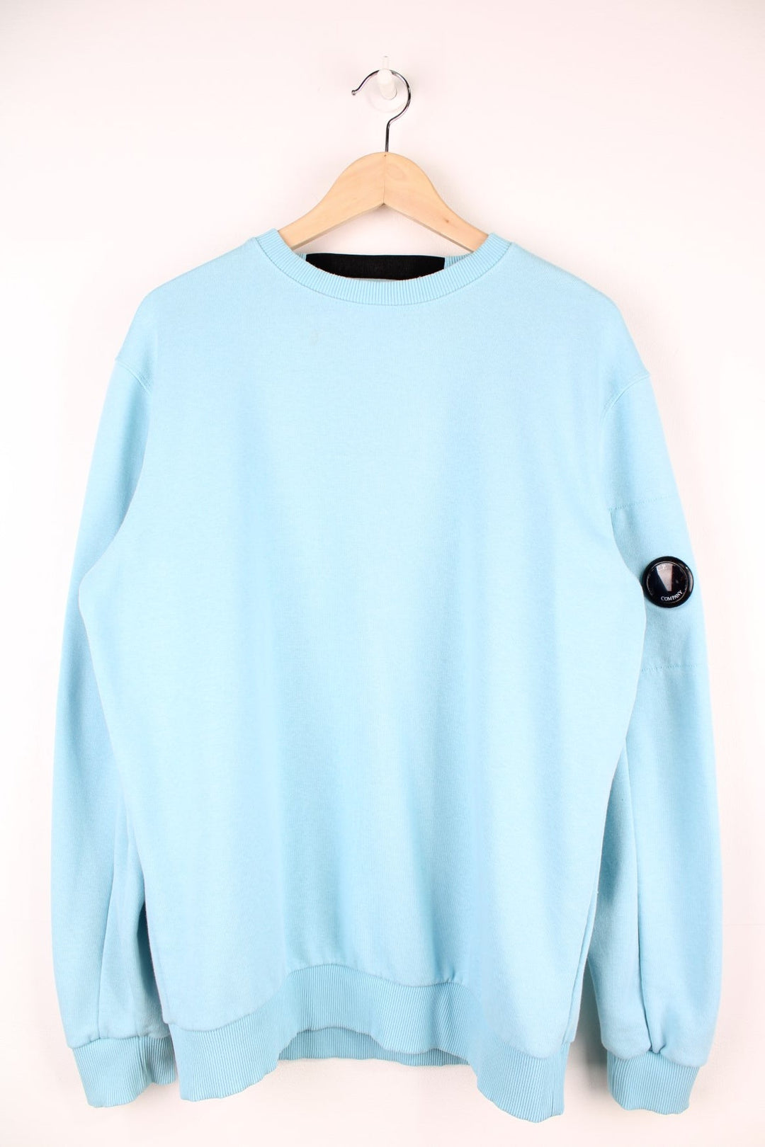 CP Company Sweatshirt in a baby blue colourway, plain crewneck with the google and pocket on the left sleeve.