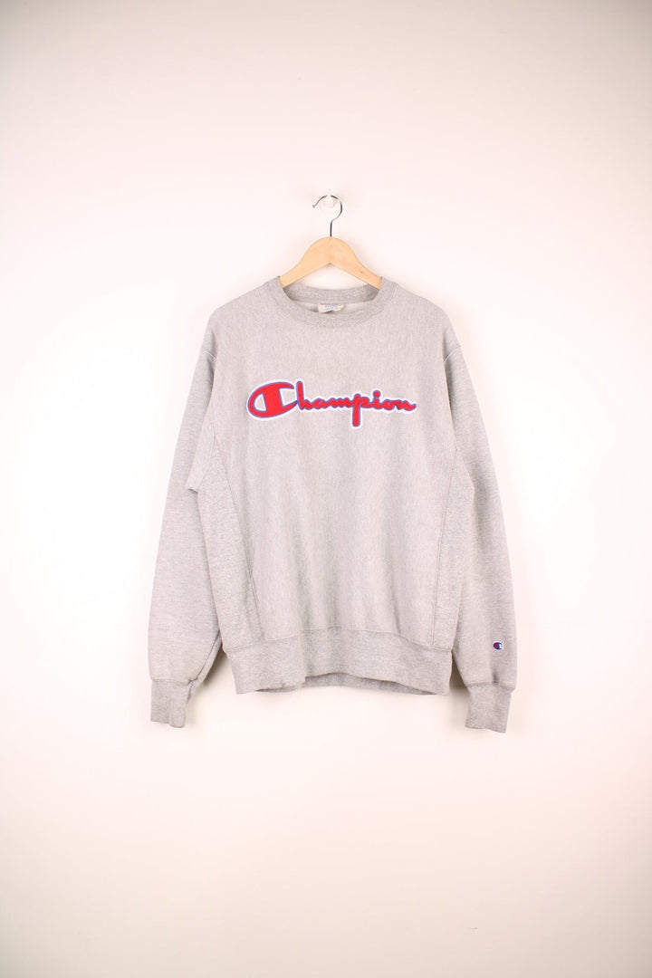 Champion Reverse Weave Sweatshirt in a grey colourway with the spell out logo embroidered across the front and on the left sleeve. 