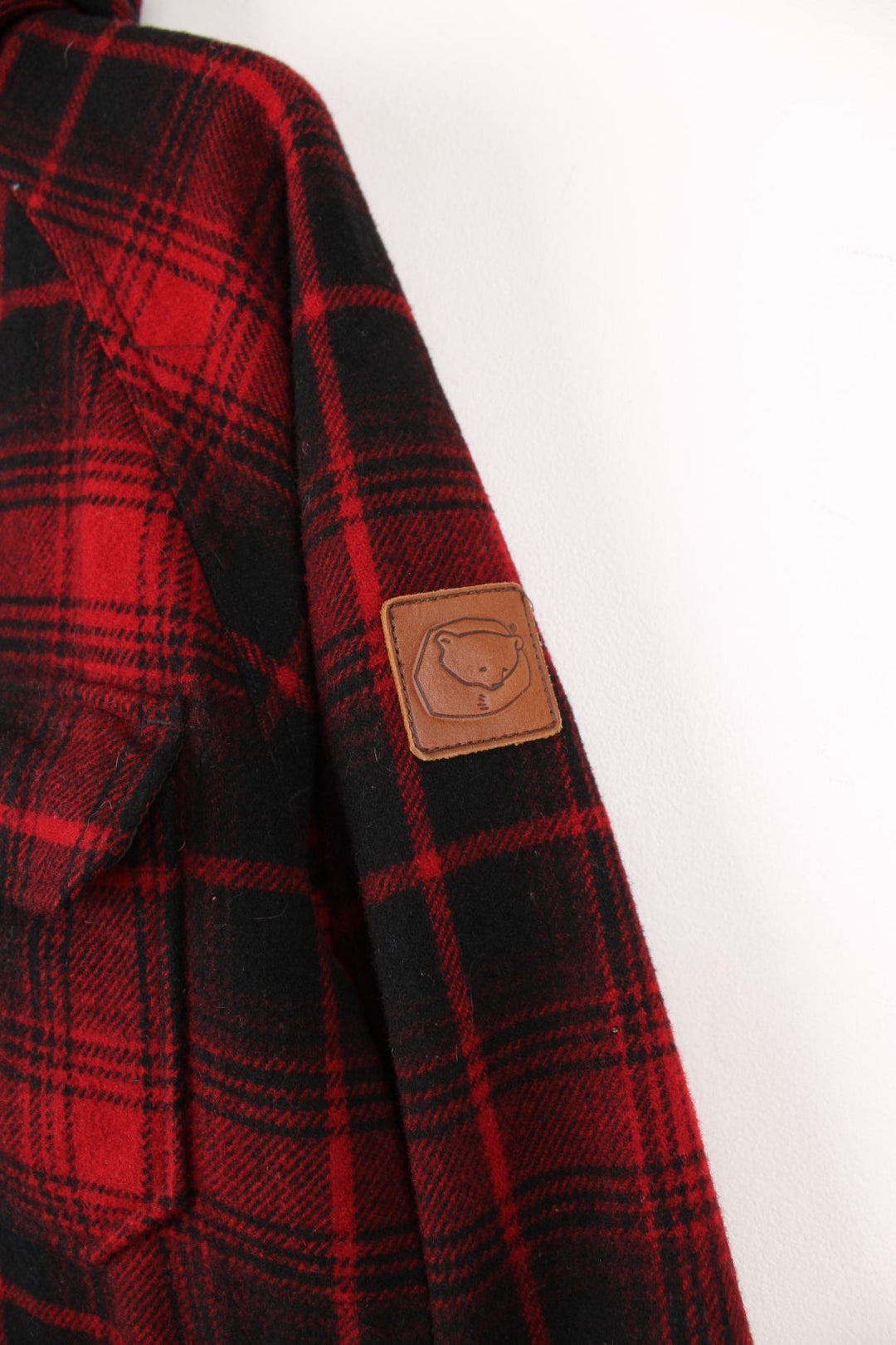 Penfield Trailwear Flannel Jacket in a red and black plaid colourway, zip up with multiple pockets, has a nylon lining, hooded and has the logo embroidered on the front. 