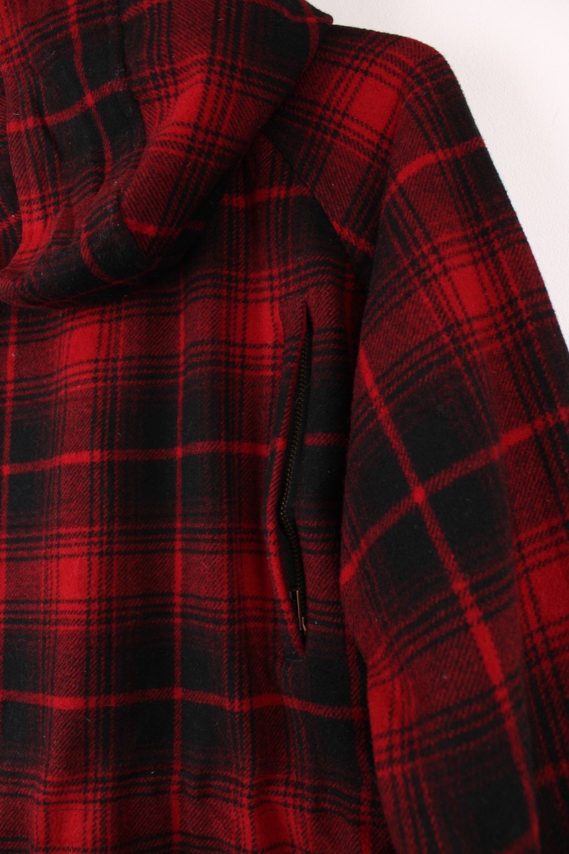 Penfield Trailwear Flannel Jacket in a red and black plaid colourway, zip up with multiple pockets, has a nylon lining, hooded and has the logo embroidered on the front. 