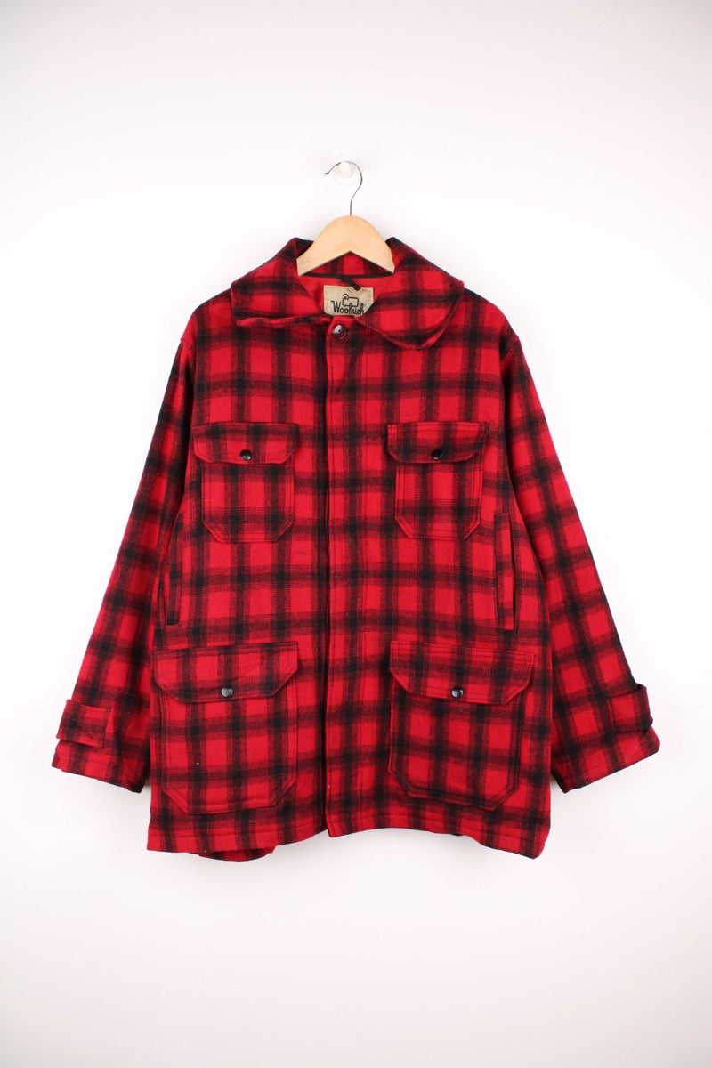 Woolrich Plaid Wool Coat in a red and black colourway, button up with a big collar, multiple pockets, and has a quilted lining. 