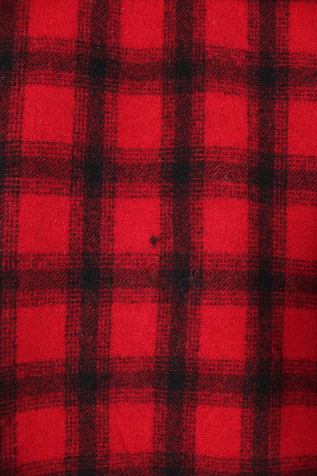 Woolrich Plaid Wool Coat in a red and black colourway, button up with a big collar, multiple pockets, and has a quilted lining. 