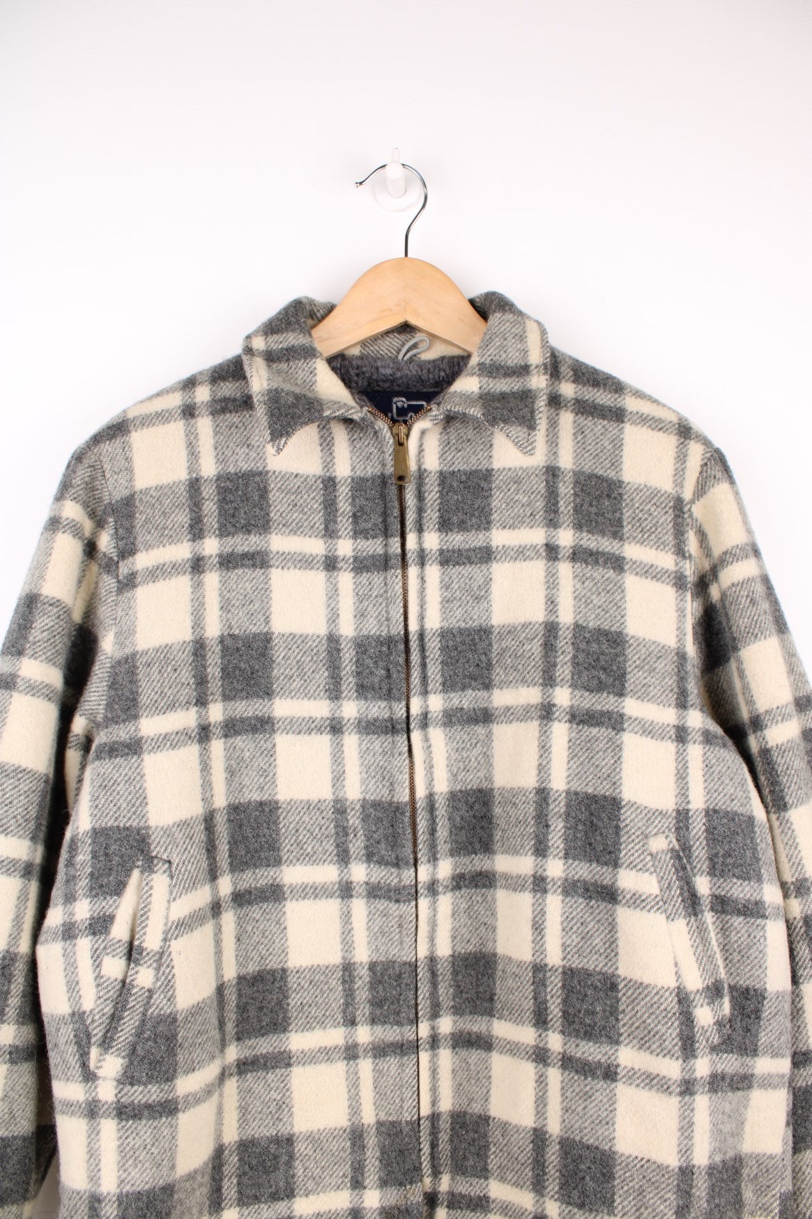 Woolrich Plaid Wool Jacket in a grey and white colourway, zip up with side pockets, and has a sherpa lining. 