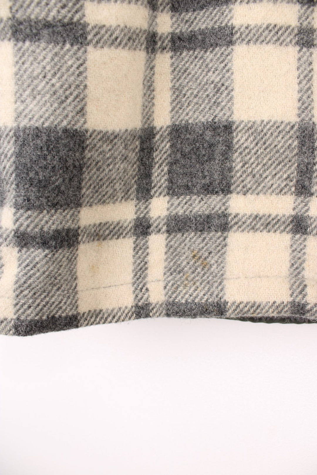 Woolrich Plaid Wool Jacket in a grey and white colourway, zip up with side pockets, and has a sherpa lining. 