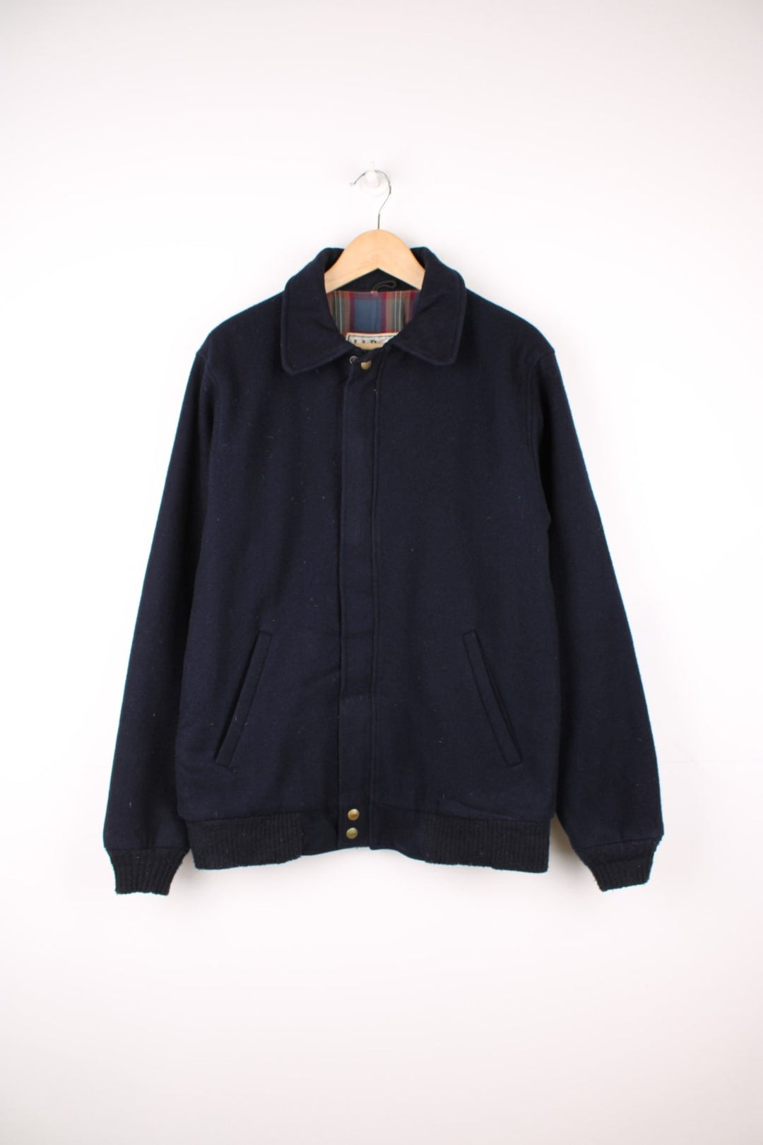 L.L. Bean Wool Bomber Jacket in a navy blue colourway, zip up with side pockets, and has a tartan cotton lining. 