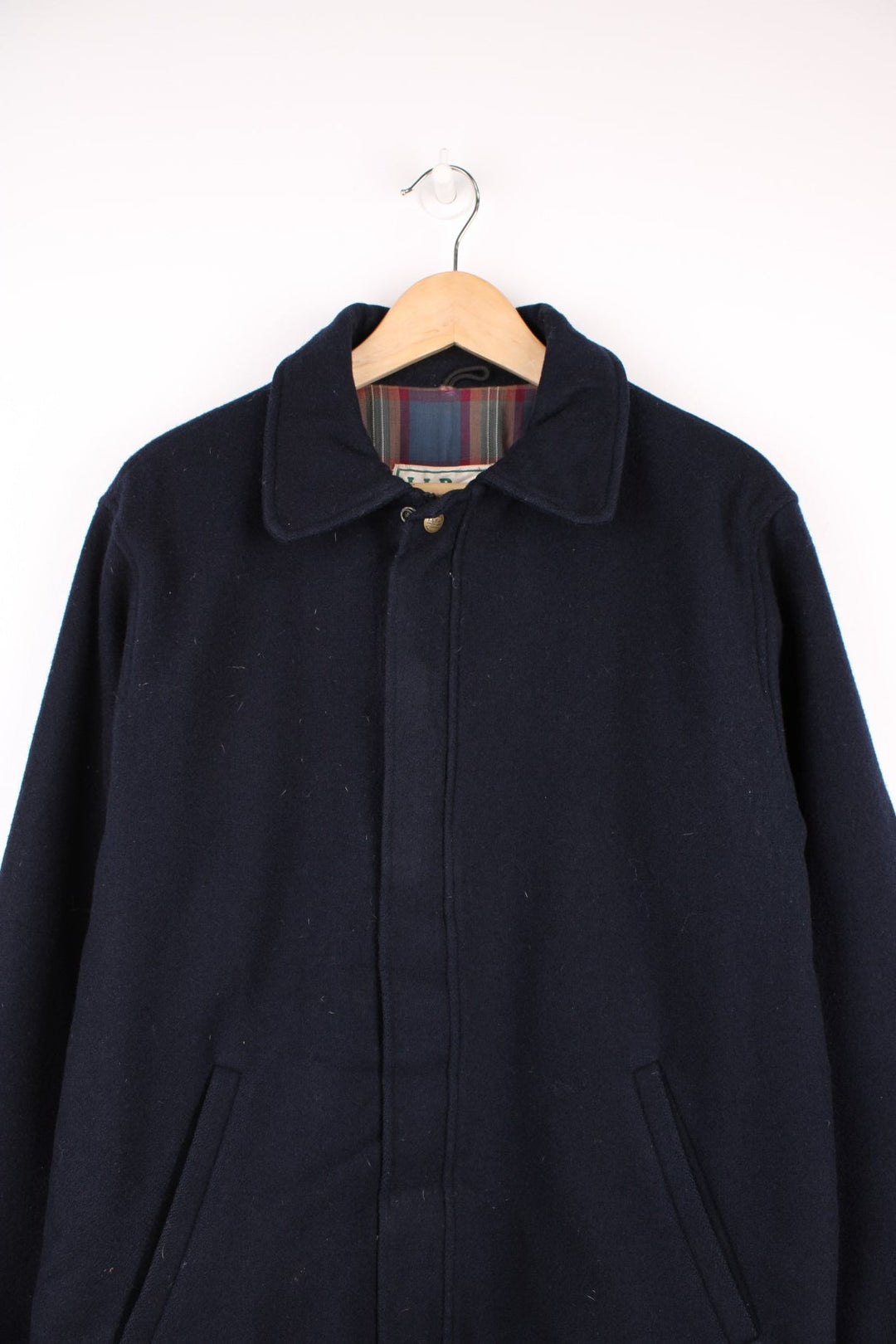 L.L. Bean Wool Bomber Jacket in a navy blue colourway, zip up with side pockets, and has a tartan cotton lining. 