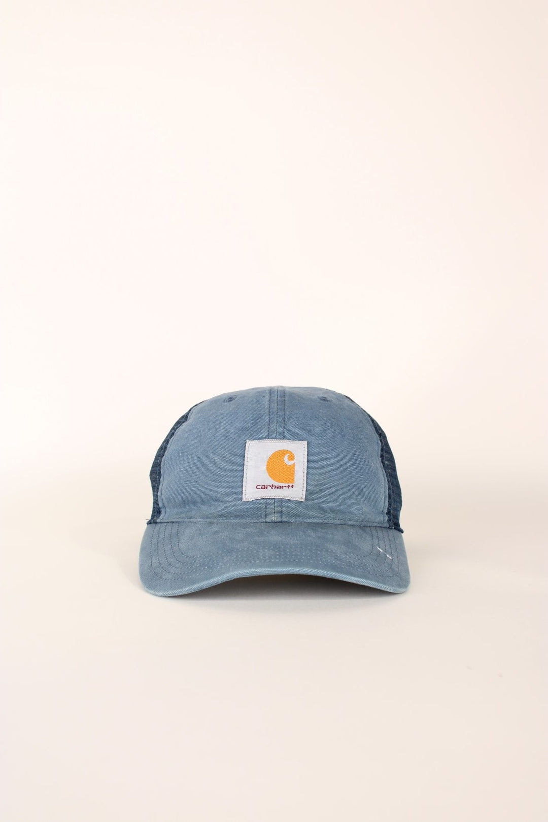 Carhartt Mesh Trucker Cap in a blue colourway with the logo embroidered on the front and has a adjustable strap on the back.