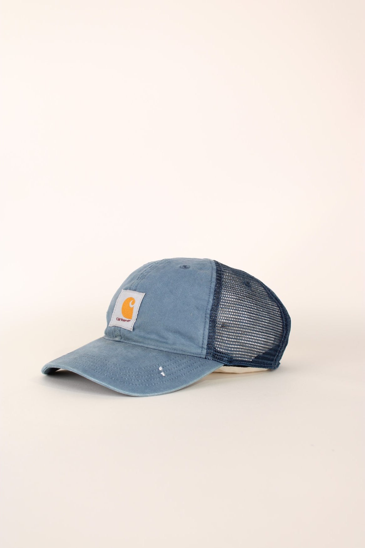 Carhartt Mesh Trucker Cap in a blue colourway with the logo embroidered on the front and has a adjustable strap on the back.