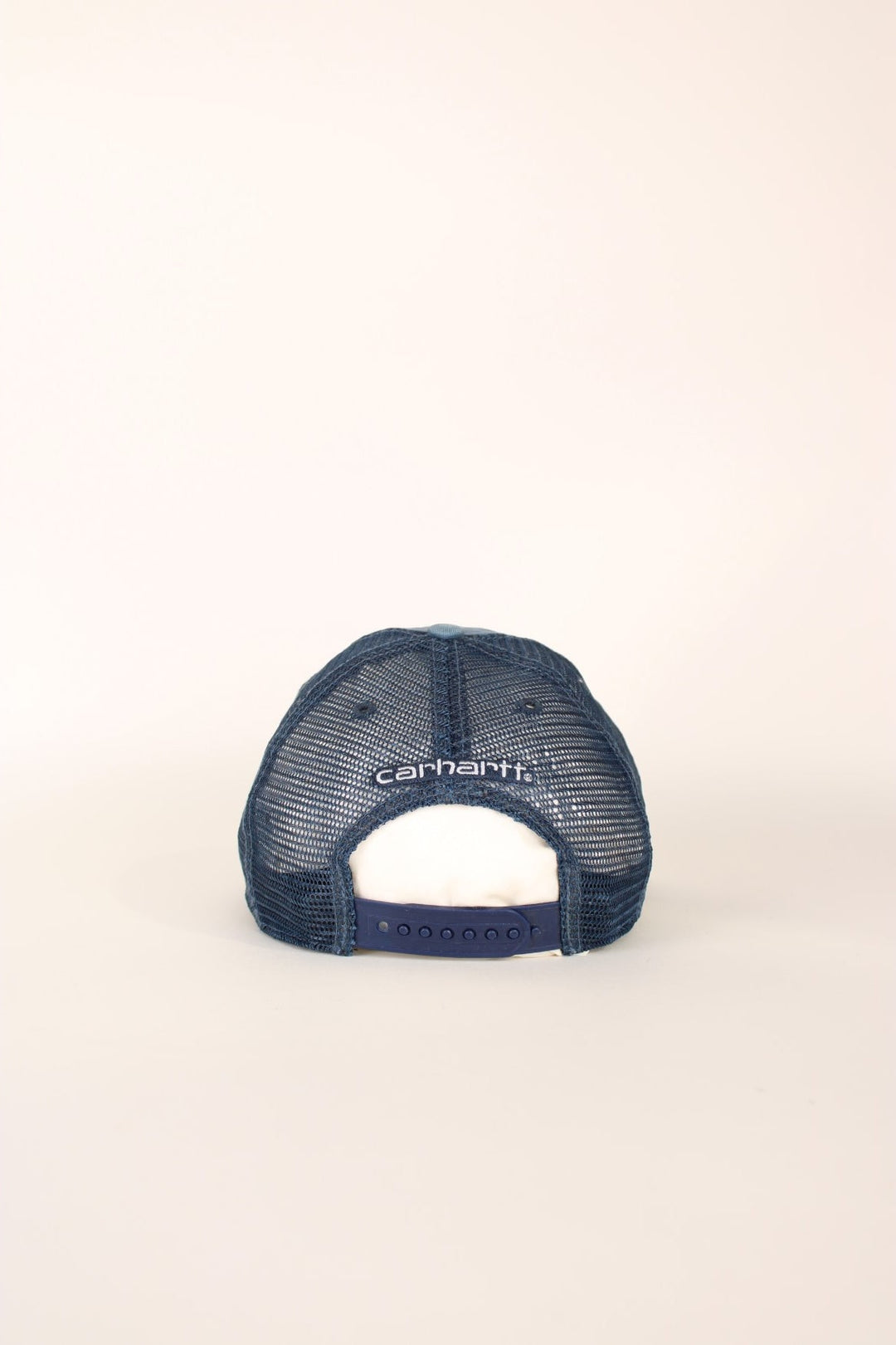 Carhartt Mesh Trucker Cap in a blue colourway with the logo embroidered on the front and has a adjustable strap on the back.