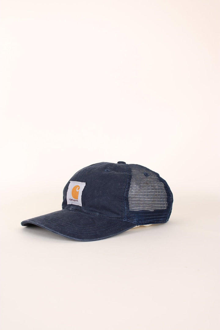 Carhartt Mesh Trucker Cap in a blue colourway with the logo embroidered on the front and has a adjustable strap on the back.