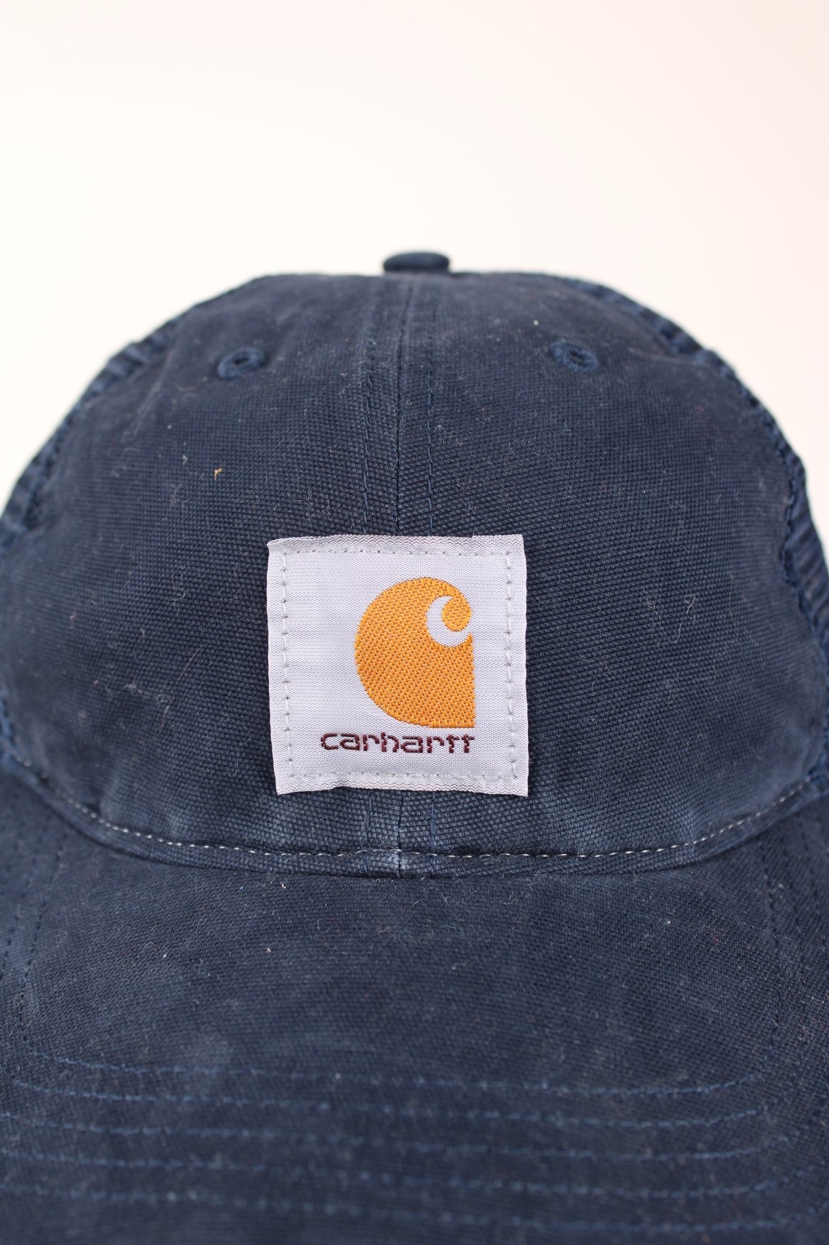 Carhartt Mesh Trucker Cap in a blue colourway with the logo embroidered on the front and has a adjustable strap on the back.