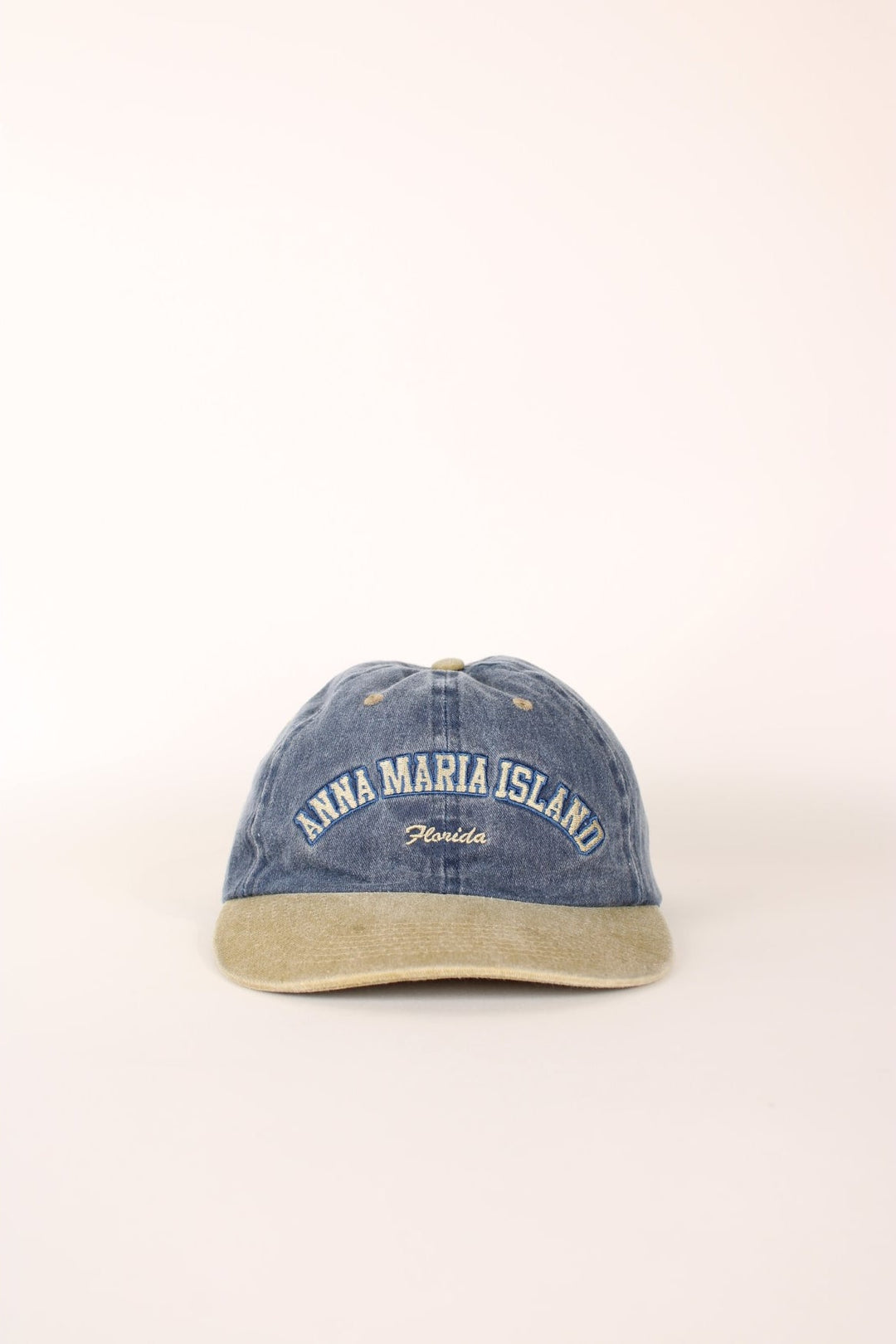 Anna Maria Island Florida Cap in a faded blue and tanned colourway with the spell out logo embroidered on the front, and has a adjustable velcro strap.