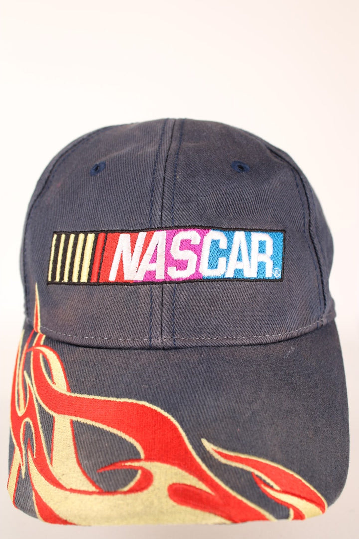 Nascar Racing Cap in a grey colourway with the spell out logo embroidered on the front as well as fire on the front cap, has a adjustable velcro strap.