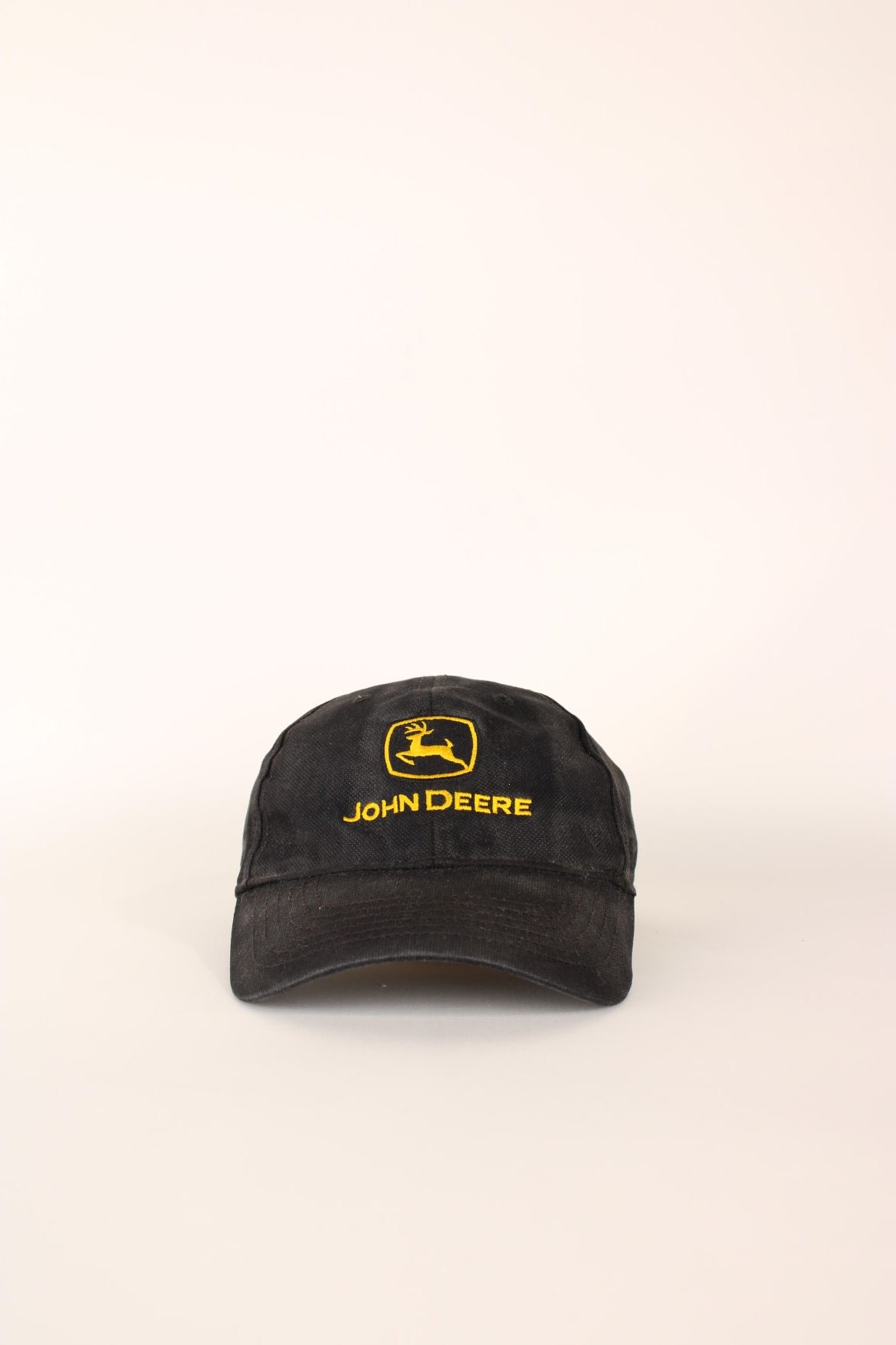 John Deere Cap in a faded black and yellow colourway with the logo embroiderd on the front and has a adjustable velcro strap.