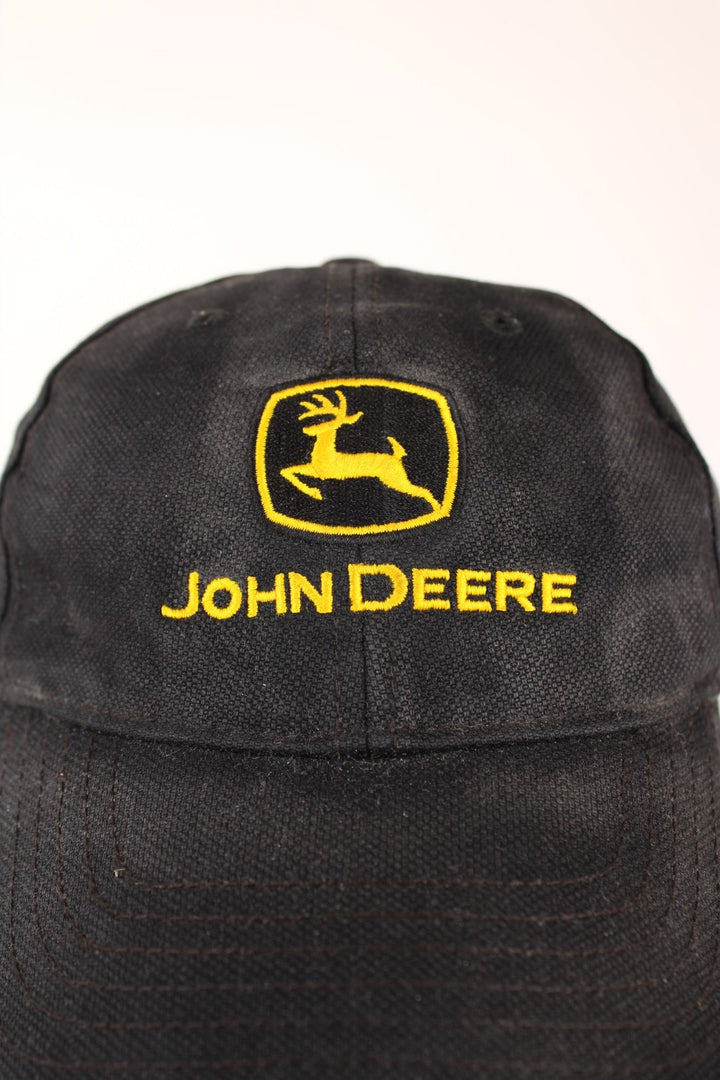 John Deere Cap in a faded black and yellow colourway with the logo embroiderd on the front and has a adjustable velcro strap.