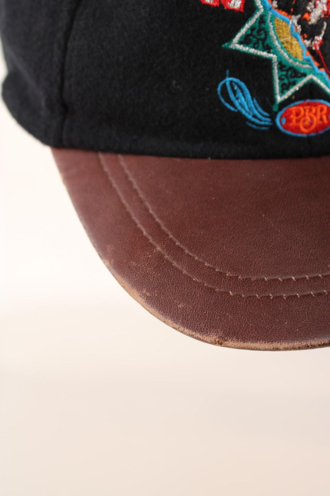 Vintage Professional Bull Riding Year 2000 Cap in a black and brown colourway with the logo embroidered on the front and Bud Light sponsor on the back, has an adjustable strap.