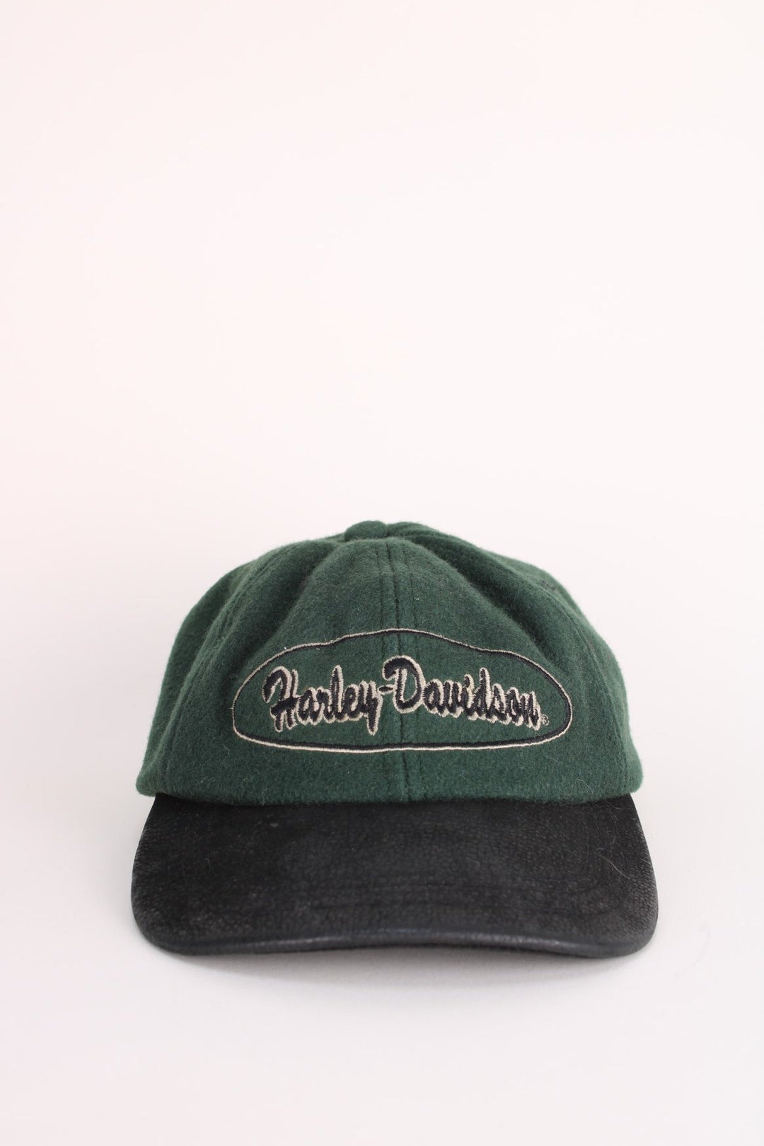 Vintage Harley-Davidson Cap in a green and black colourway with the spell out logo embroidered on the front, and has an adjustable leather strap.