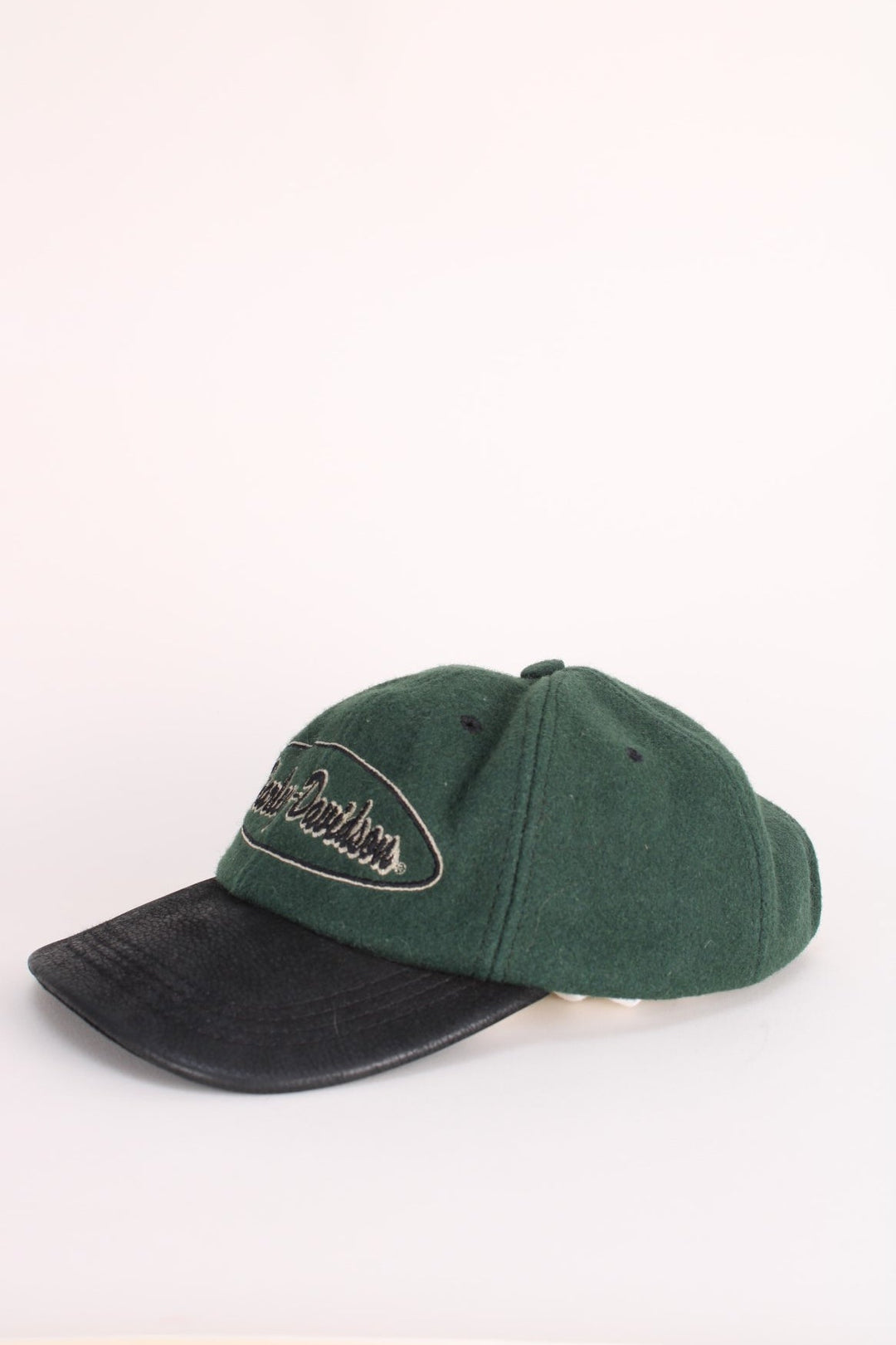 Vintage Harley-Davidson Cap in a green and black colourway with the spell out logo embroidered on the front, and has an adjustable leather strap.