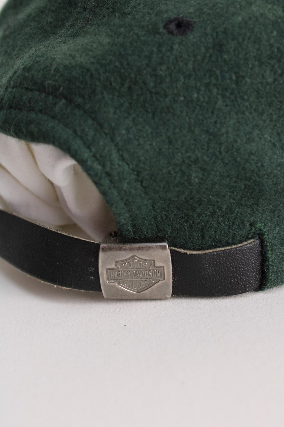 Vintage Harley-Davidson Cap in a green and black colourway with the spell out logo embroidered on the front, and has an adjustable leather strap.