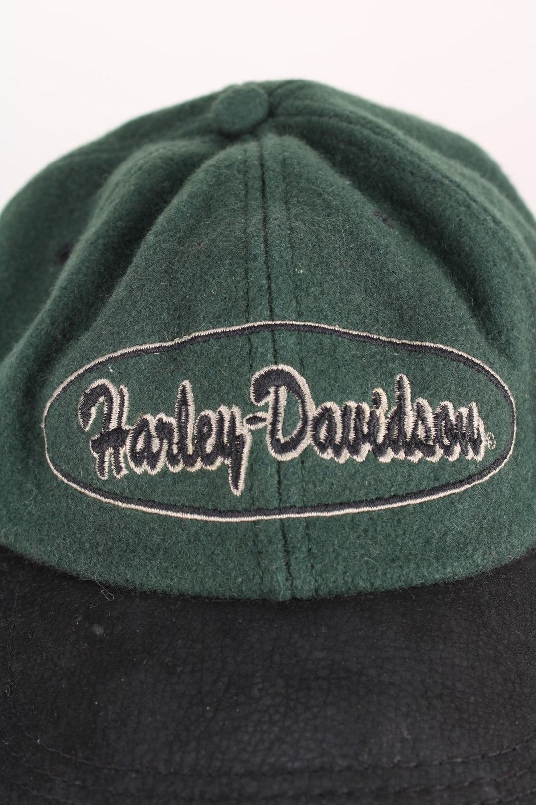 Vintage Harley-Davidson Cap in a green and black colourway with the spell out logo embroidered on the front, and has an adjustable leather strap.