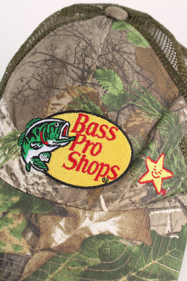 Vintage Bass Pro Shops Camo Cap in a green and brown colourway with the logo embroidered on the front, and has an adjustable snapback.