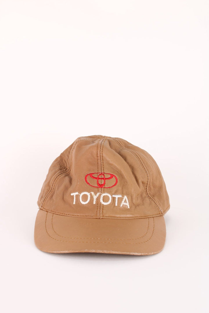 Vintage Toyota Leather Cap in a brown colourway with the logo embroidered on the front, and has an adjustable velcor strap.