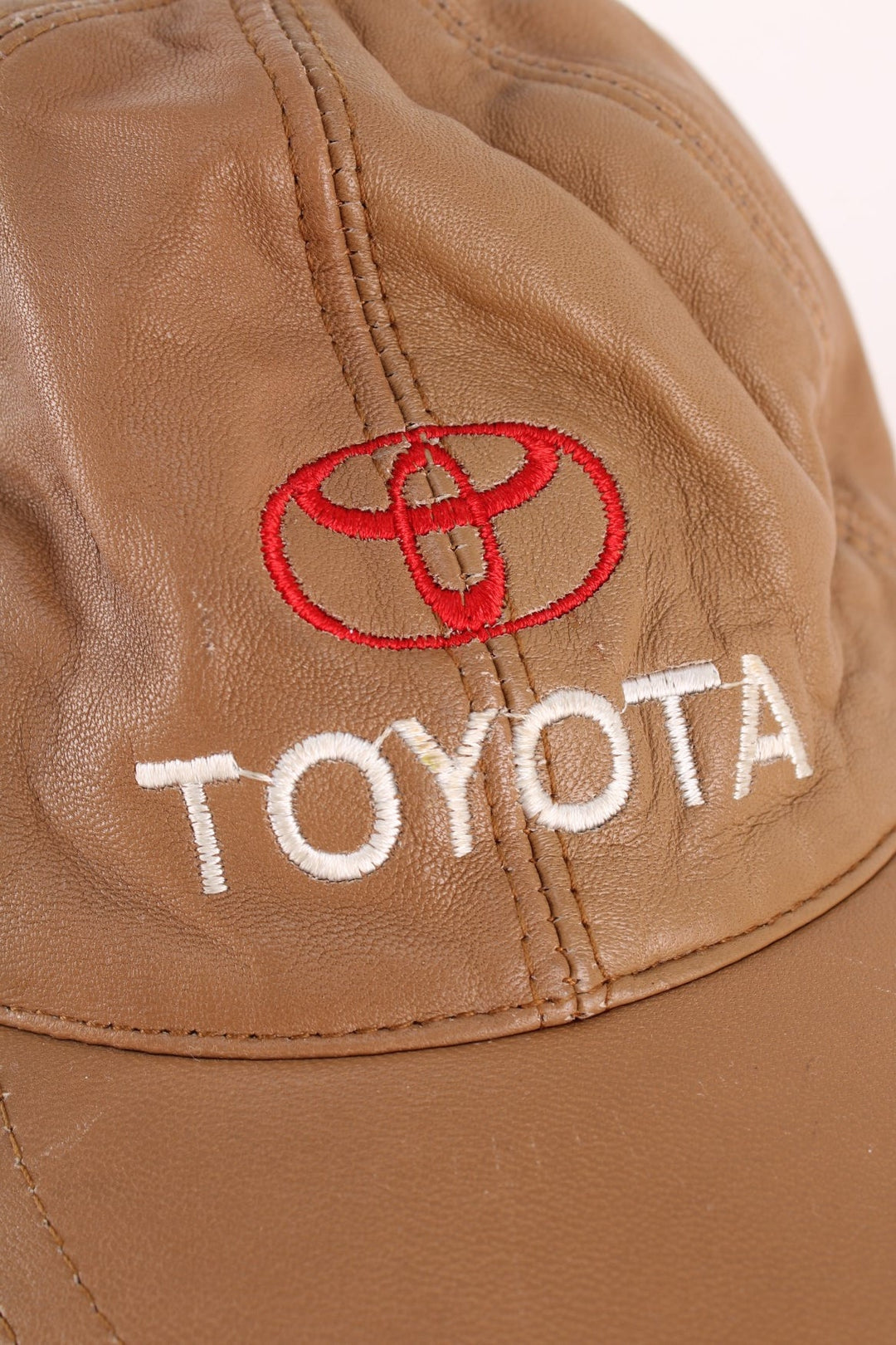 Vintage Toyota Leather Cap in a brown colourway with the logo embroidered on the front, and has an adjustable velcor strap.