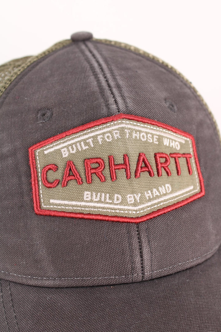 Carhartt Silvermine Trucker Cap in a grey and green colourway with the logo embroidered on the front, and has an adjustable snapback.