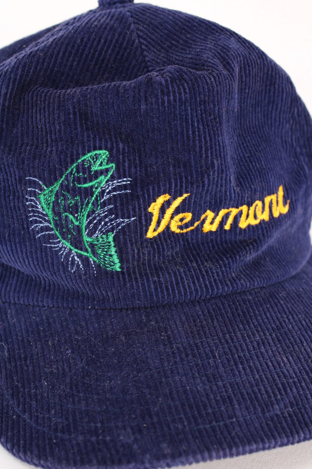 Vintage Vermont Corduroy Trucker Cap in a blue colourway with the logo and fish graphic printed on the front, and has an adjustable snapback.