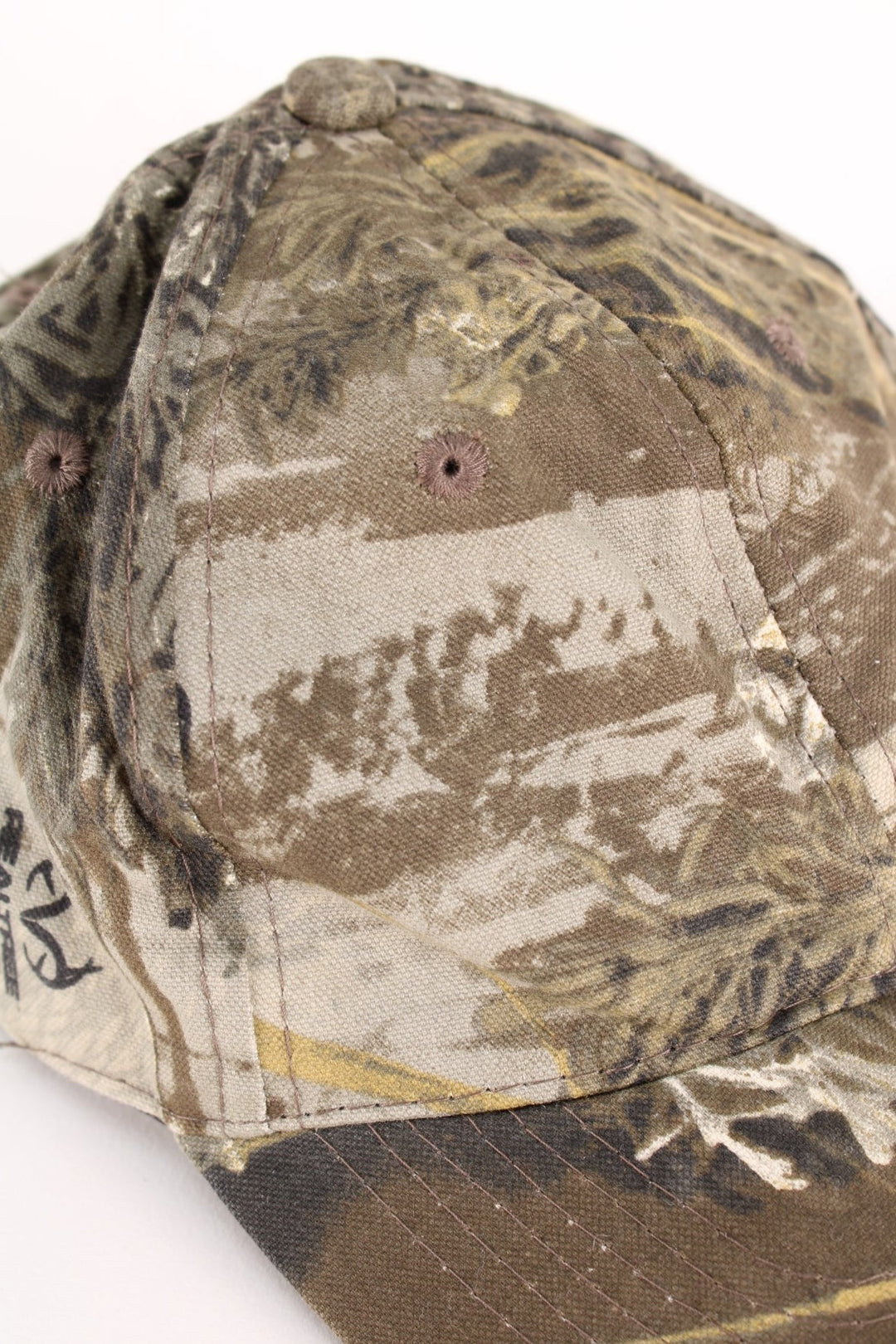 Vintage Real Tree Camo Cap in a green and brown colourway and has an adjustable velcro strap.